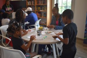 Precious Christian (second to the right) plays a counting game with her children MJ Bryant and Pre’Ciyah Turner. Photo by Liz Wright.